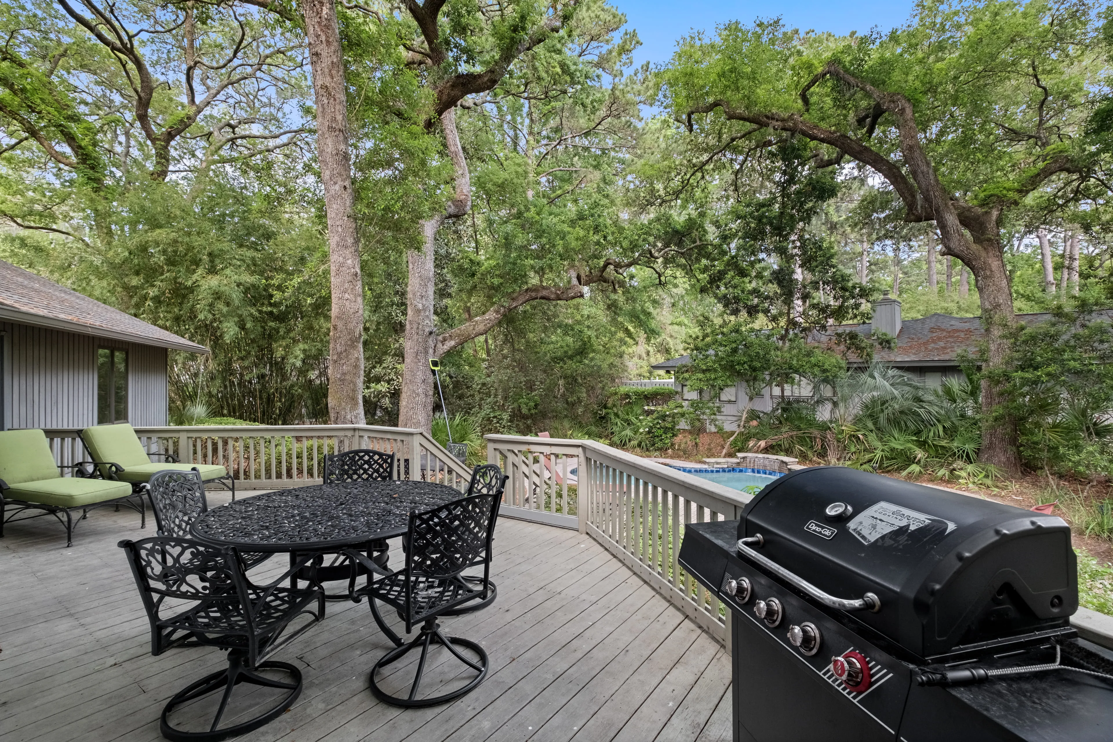 Back deck with patio table, lounge chairs, and gas grill