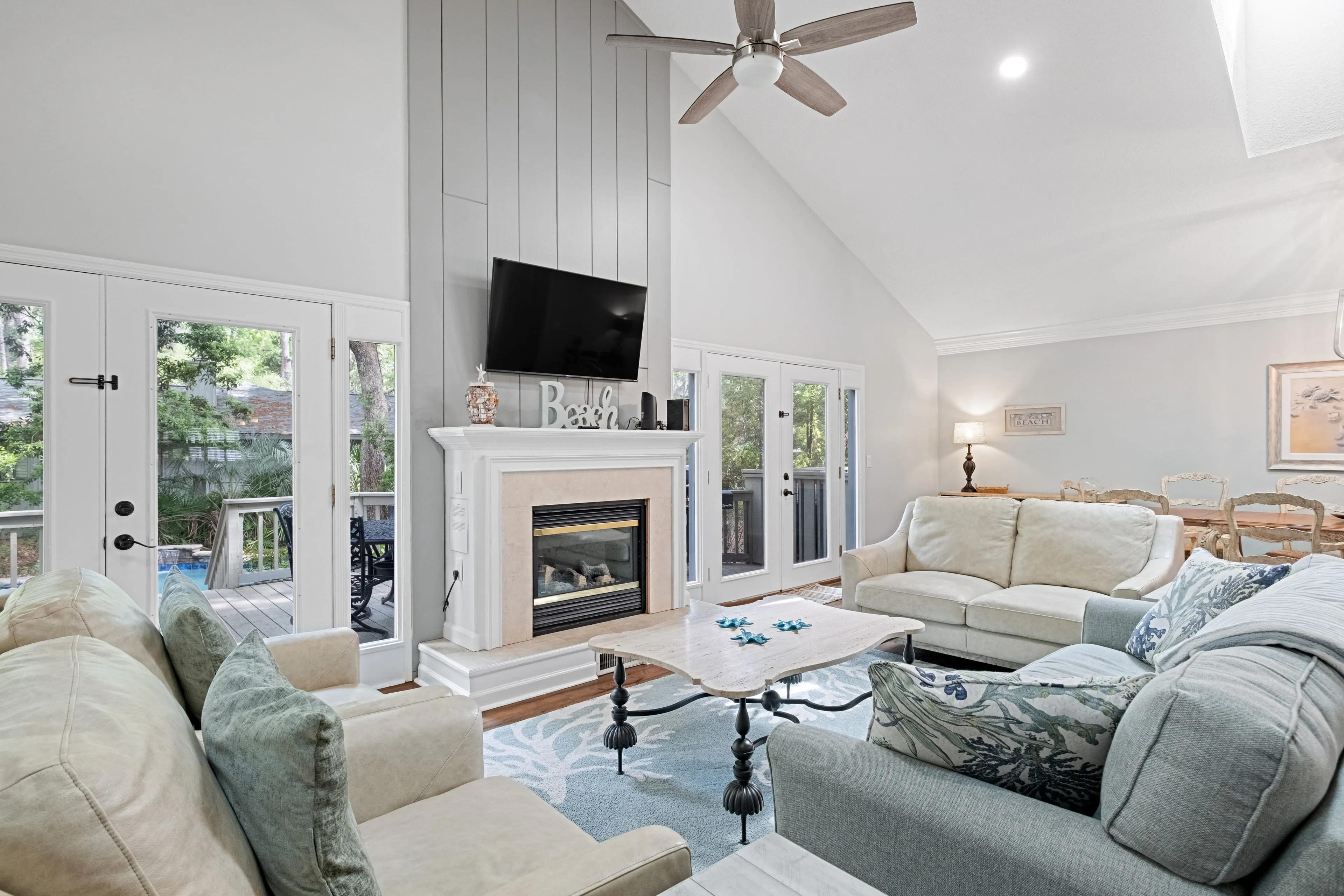 Vaulted-ceiling great room with fireplace and beach decor